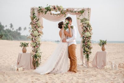 Bride & Groom beach wedding. Image b PhotoSunnyDays via Shutterstock.