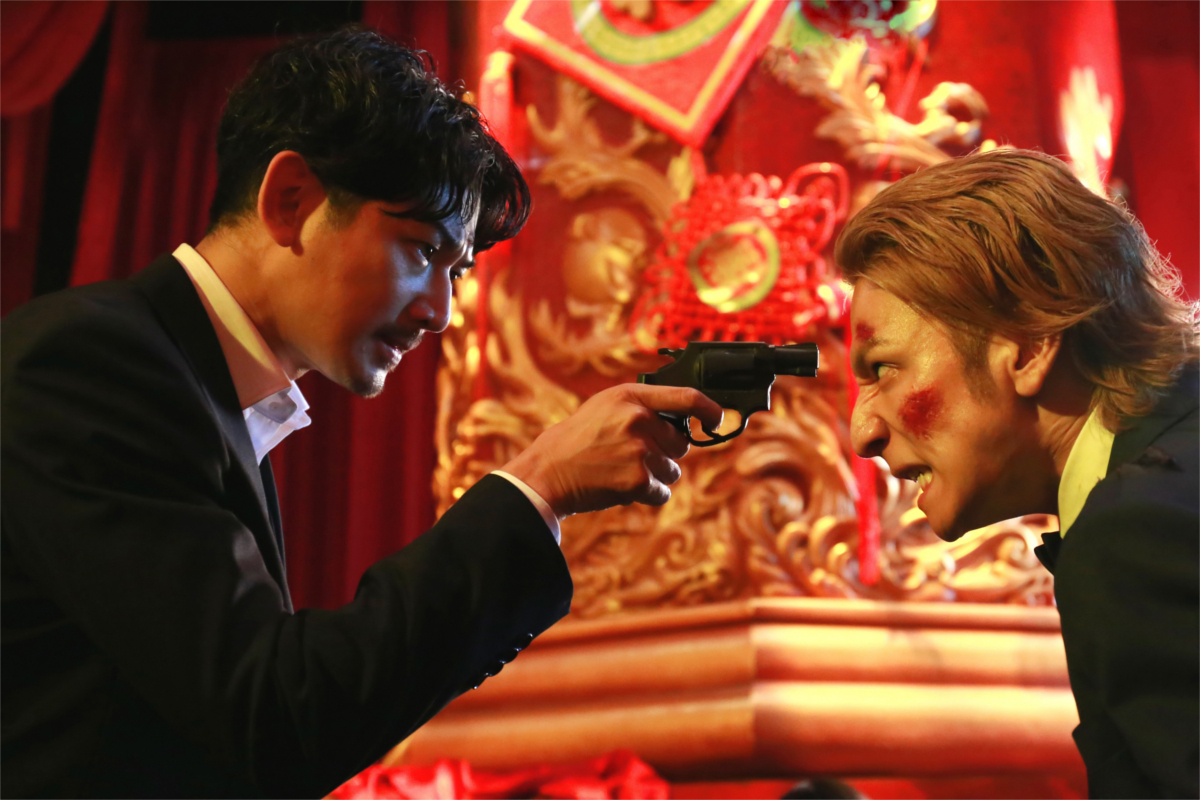 main characters fighting with a gun 