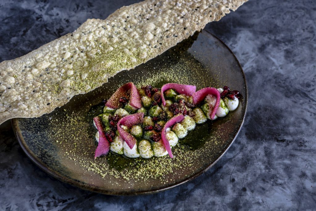 Labne with nigella bread, pomegranate, pink pickle, pistachio and basil