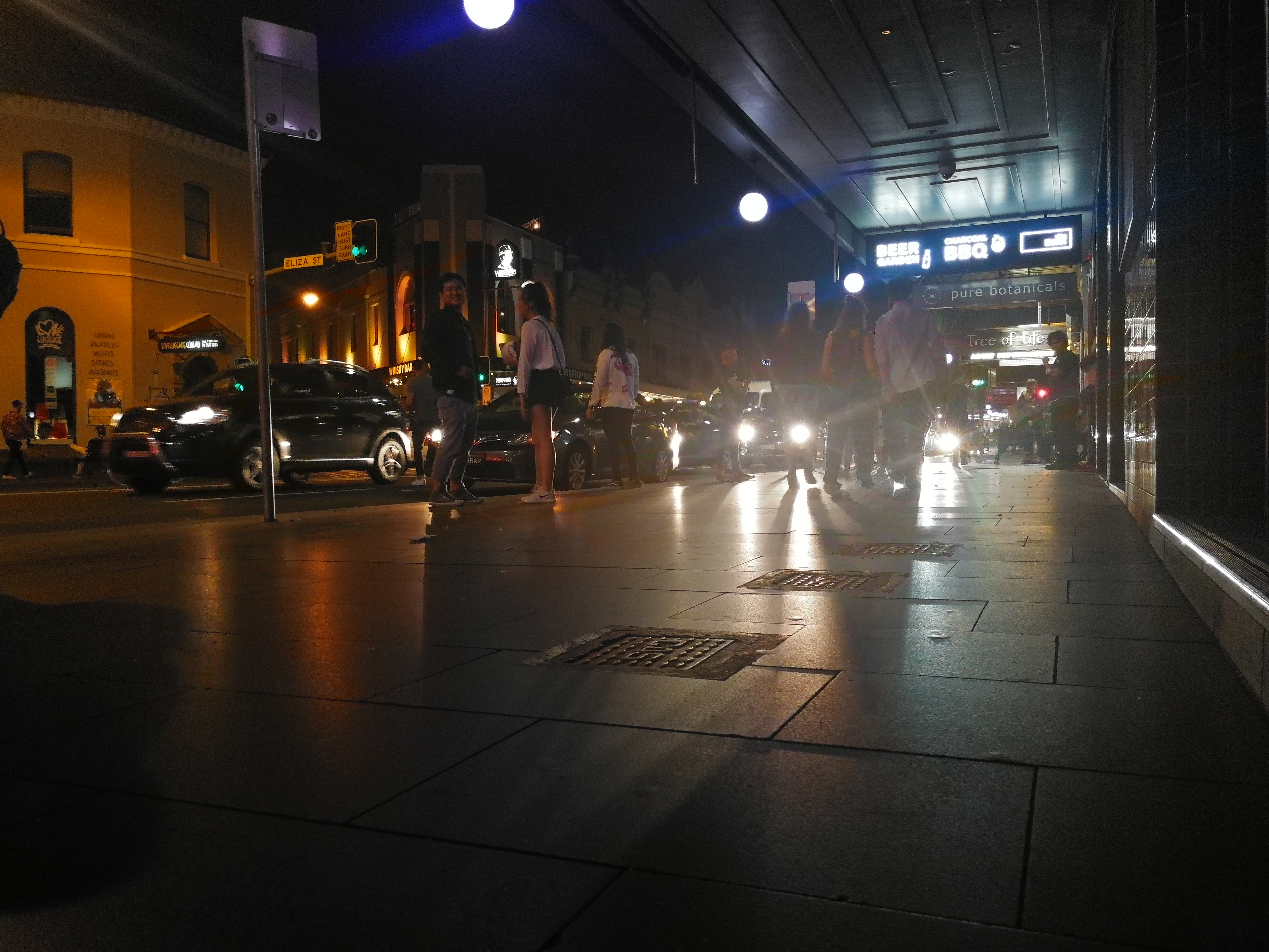 Cars beam their lights down King Street while revellers search for a party. Image: Christopher Kelly