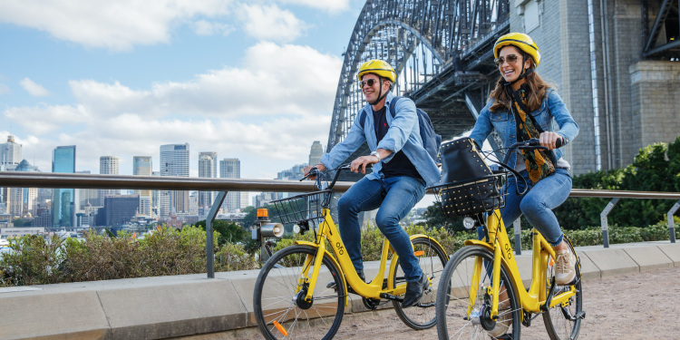 Two riders ride ofo bikes along Sydney Harbour. Image: Supplied