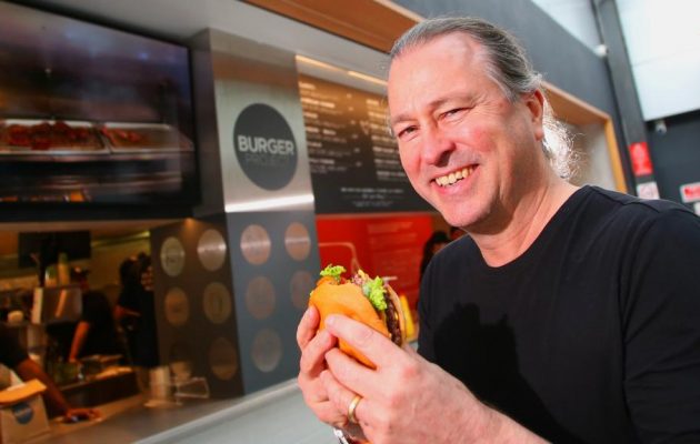 Niel Perry, Culinary Director at Rockpool Dining Group, enjoys a delicious burger. Image: Supplied.