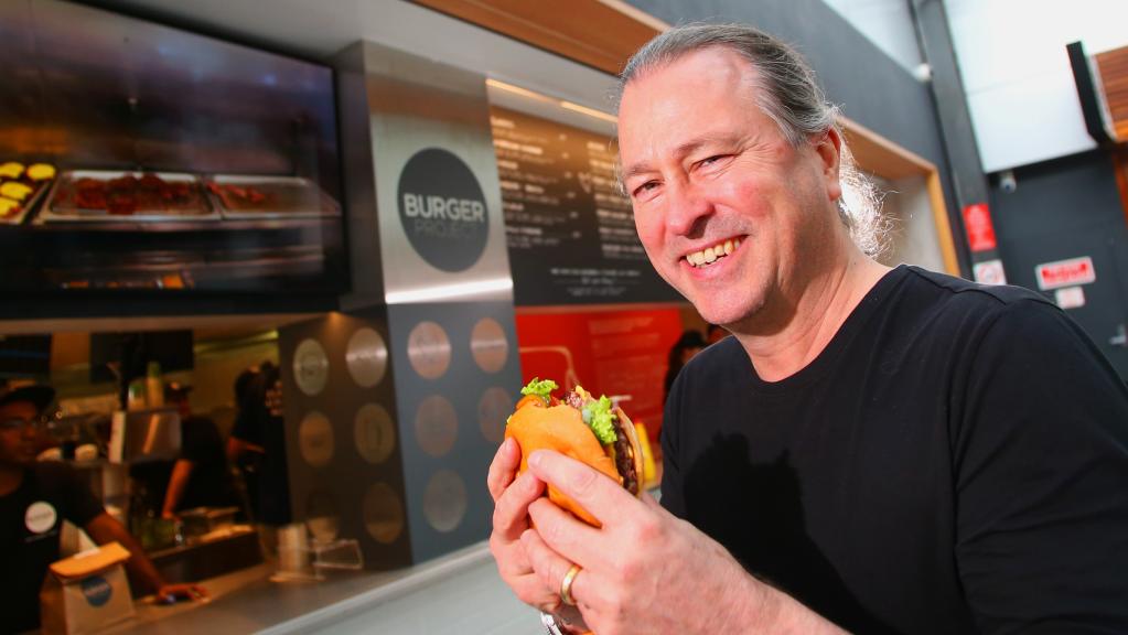 Niel Perry, Culinary Director at Rockpool Dining Group, enjoys a delicious burger. Image: Supplied.