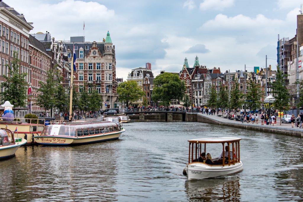 Boat on canal Amsterdam. Image by Daniel Klein via Unsplash.