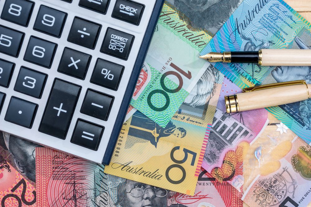 Australian money, calculator, pen. Photographed by RomanR. Image via Shutterstock