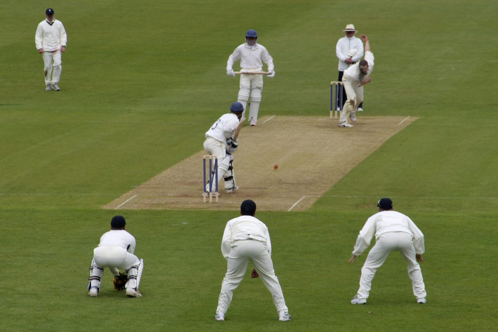 Cricket fielders in position. Photographed by Lance Bellers. Image via Shutterstock.