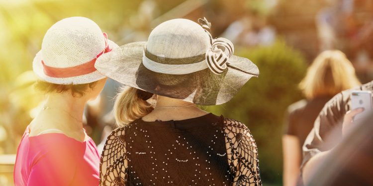 Ladies with hats on race track. Image by Nadezda Murmakova via Shutterstock.