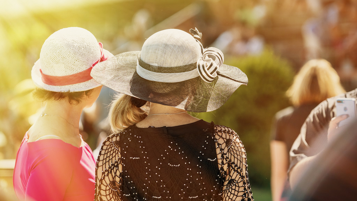 Ladies with hats on race track. Image by Nadezda Murmakova via Shutterstock.
