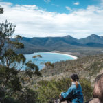 Hiking woman admires Wineglass bay. Image by Klara Zamourilova via Shutterstock.