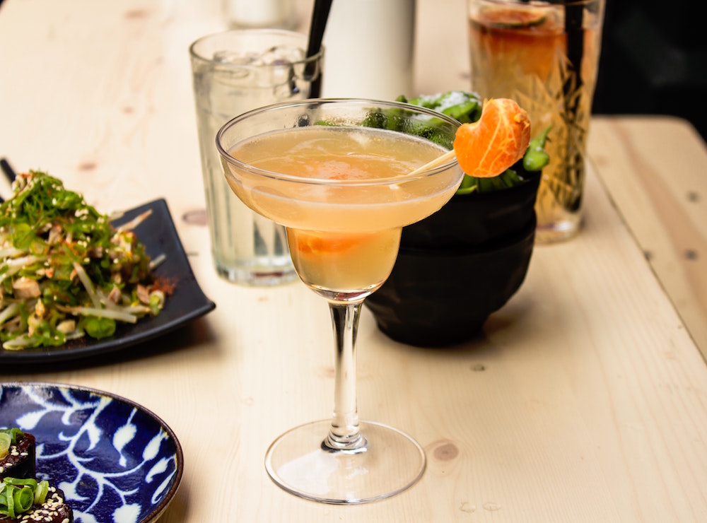 Cocktail on table. Image by Louis Hansel via Unsplash.