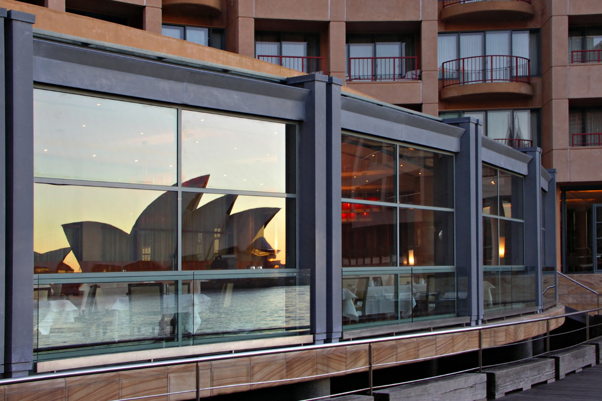 Sydney hotel with reflection of Sydney Opera House. Photography by Neale Cousland. Image via Shutterstock