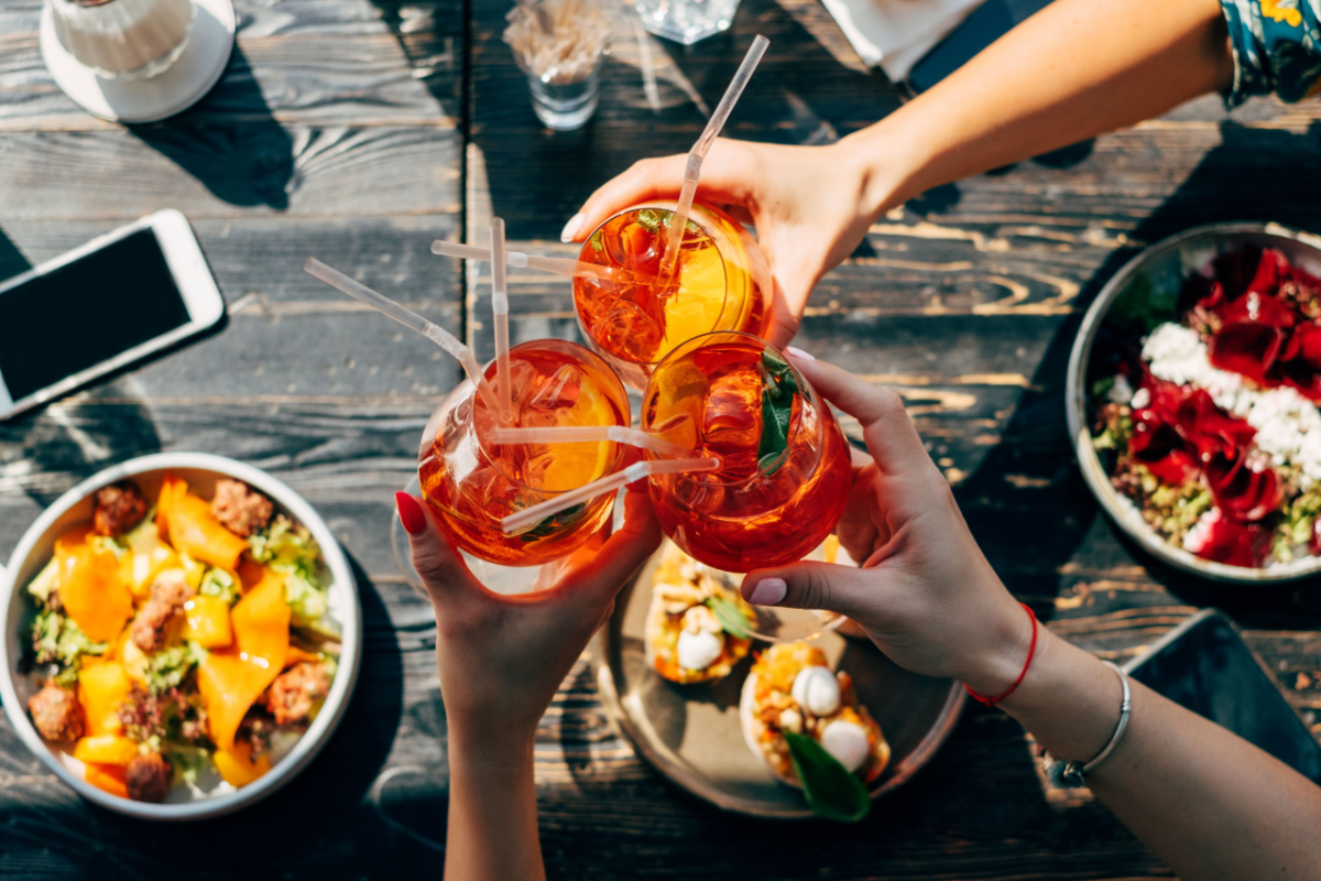 Friends toasting over brunch. Photography by Dulin. Image via Shutterstock