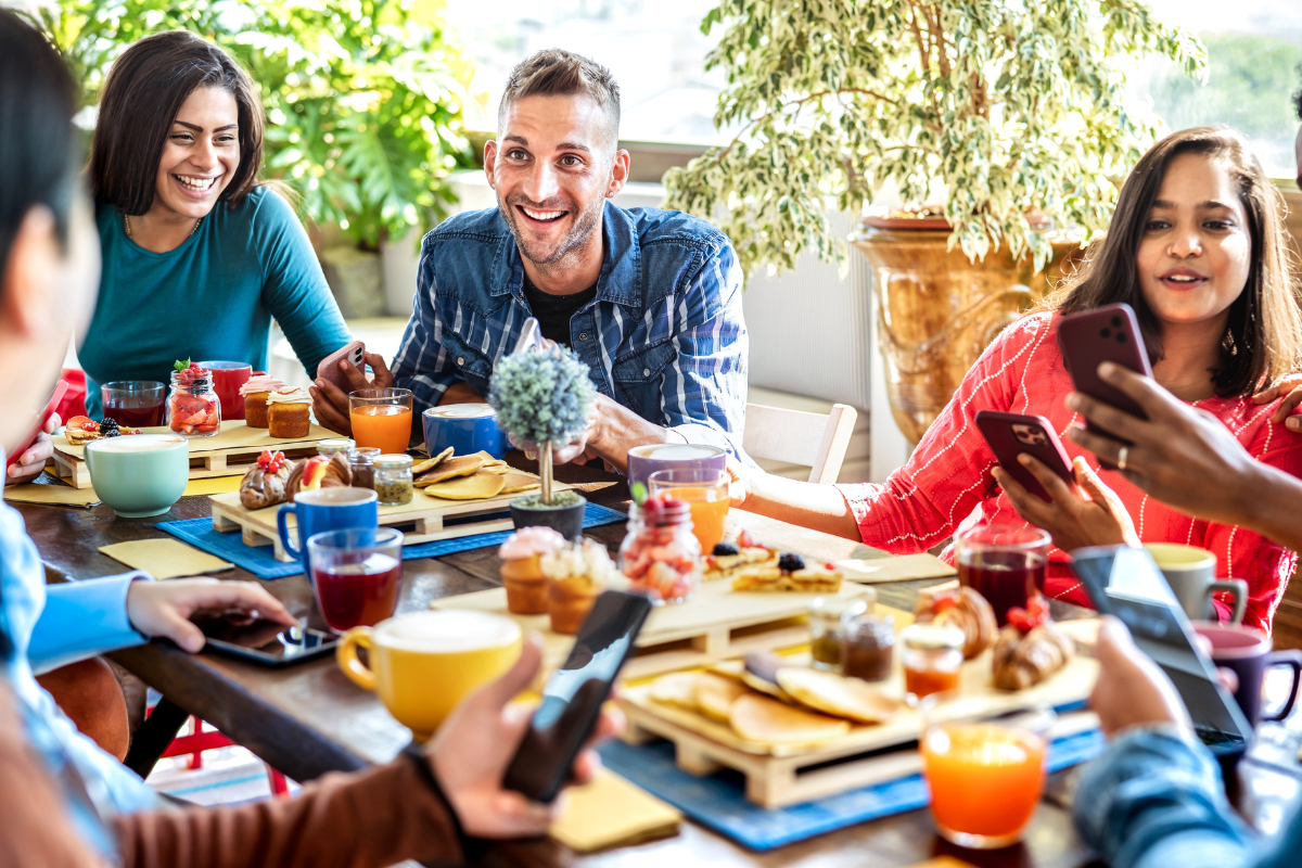 Friends interacting at coffee bar. Photography by View Apart. Image via Shutterstock