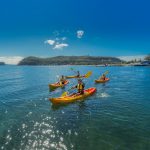 Friends kayaking on Pittwater near Boathouse Restaurant and Palm Beach Lighthouse. Image: Destination NSW