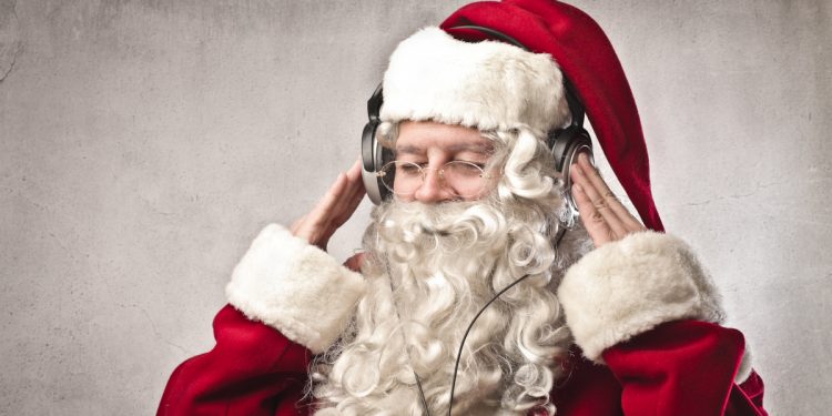Santa Claus listening to msuic. Image: Ollyy / Shutterstock