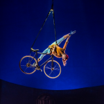 The contorting woman on a bike. Image: Martin Girard / shootstudio.ca Costumes: Philippe Guillotel © 2014 Cirque du Soleil