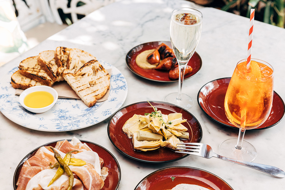 The Winery's Bottomless Prosecco and Aperol Spritz Fountain and dishes from the summer menu. Photographed by Jasper Ave. Image supplied.