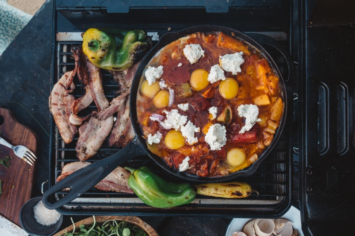 Sarah Glover WILD_ Adventure Cookbook. Heirloom Tomato Shakshuka with Bacon Salsa. Image supplied