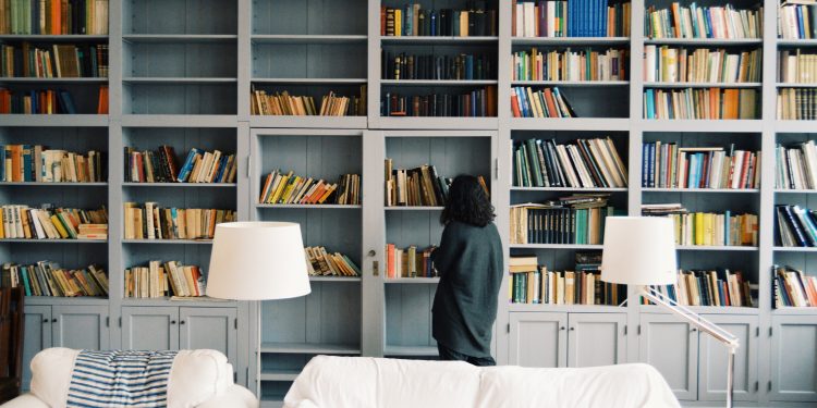 Woman looks for books.