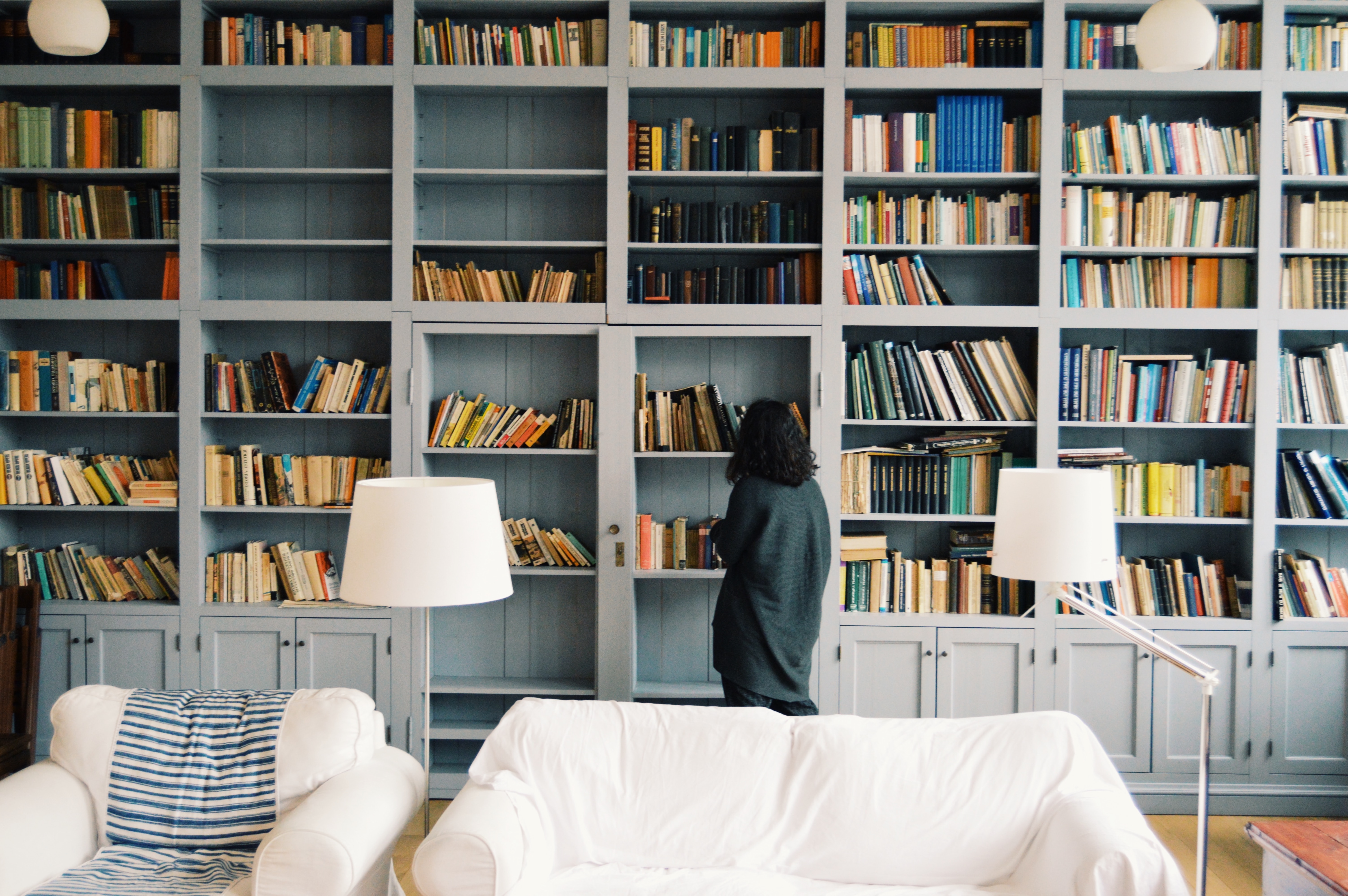 Woman looks for books.