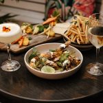 The Big Easy bar bites, roasted carrot hummus (Left), charred giant shrimp (bottom) and shoestring fries. Image: Supplied