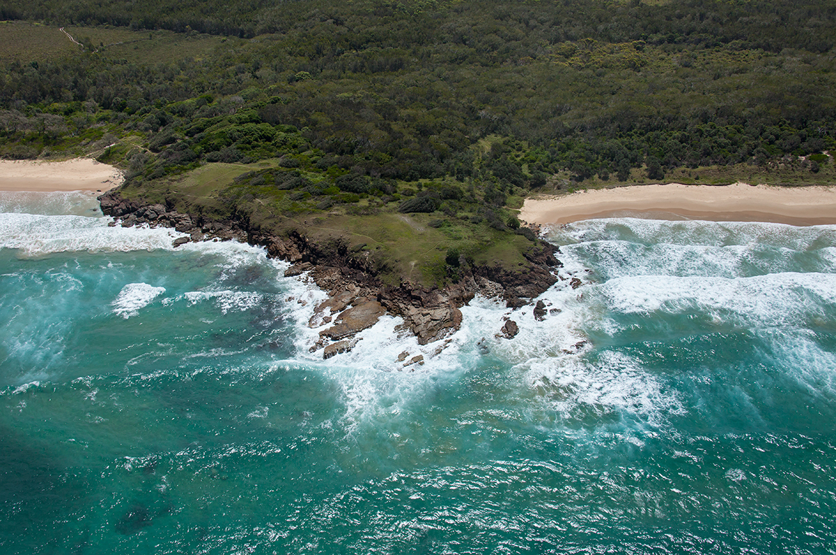 The small headland dividing Emerald Beach and Sandy Beach on the Coffs Coast. Image via Destination NSW