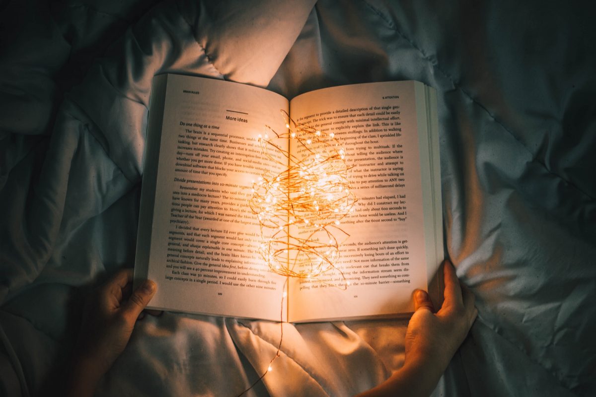 Book with stringed lights. Photographed by Nong Vang. Image via Unsplash
