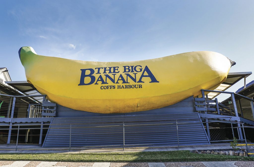 Sun shining over the sign welcoming visitors to The Big Banana attraction in Coffs Harbour. Image via Destination NSW