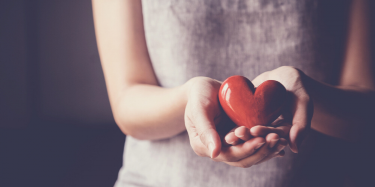 Hands holding heart. Photographed by SewCream. Image via Shutterstock