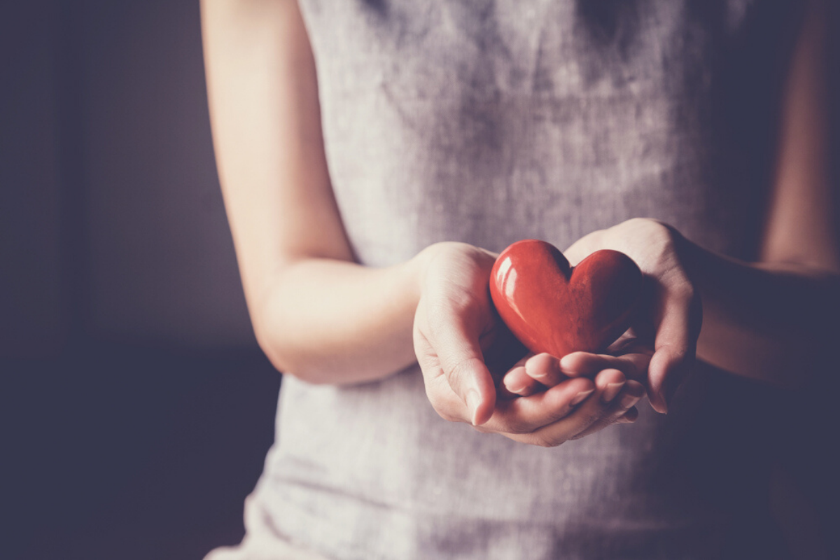Hands holding heart. Photographed by SewCream. Image via Shutterstock