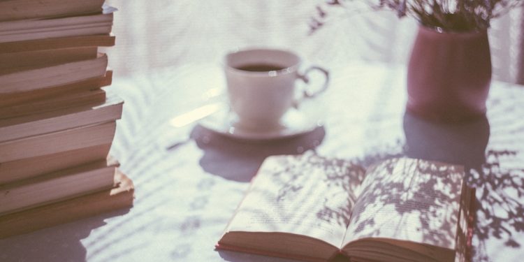 Drink and Open Book. Photographed by freestocks. Image via Unsplash.