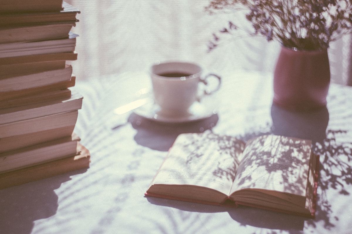Drink and Open Book. Photographed by freestocks. Image via Unsplash.