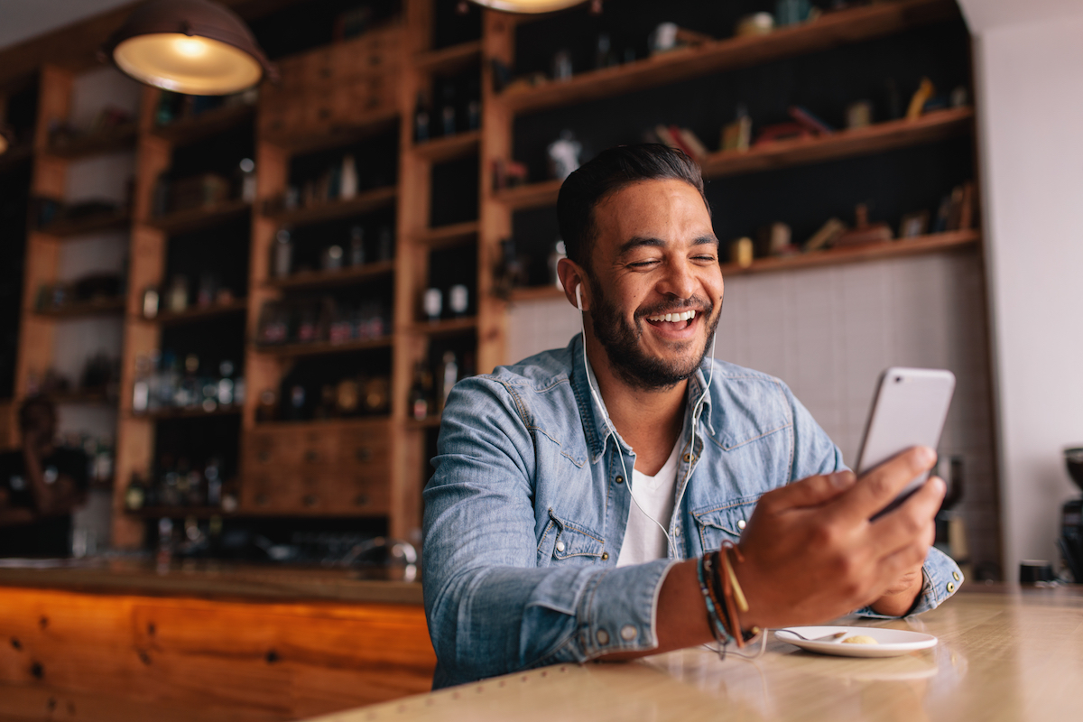 A man takes a happy video call.