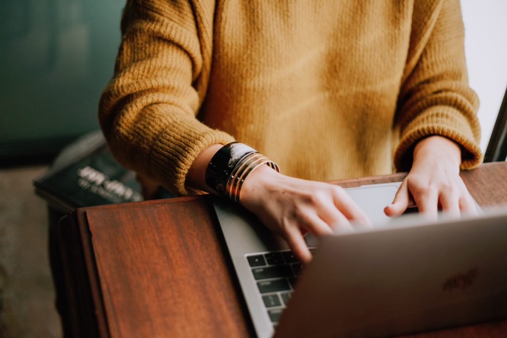 Woman typing on laptop. 