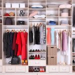 Clothes in a wardrobe. Photographed by New Africa. Image via Shutterstock