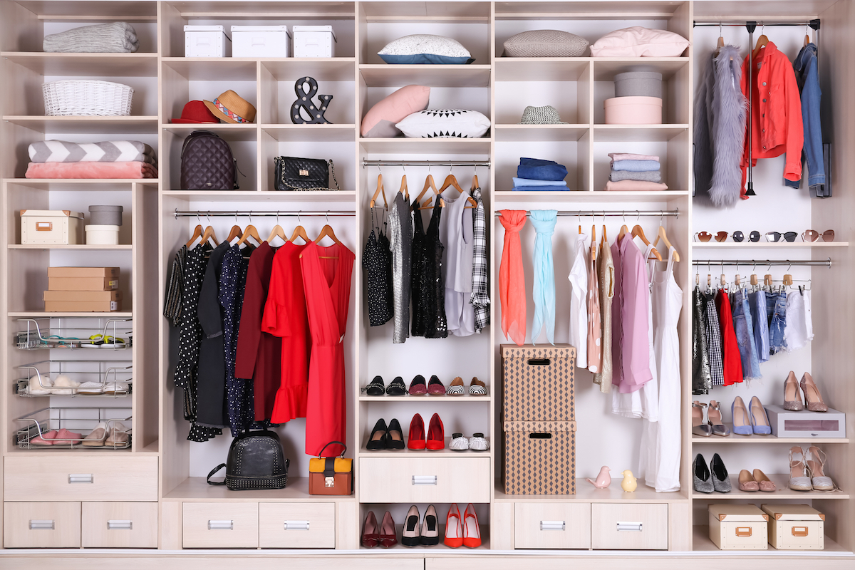 Clothes in a wardrobe. Photographed by New Africa. Image via Shutterstock