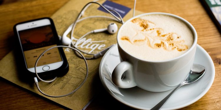 Phone and Coffee on Table.