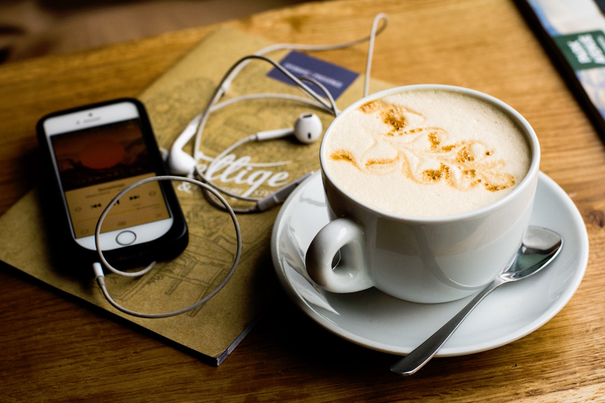 Phone and Coffee on Table.