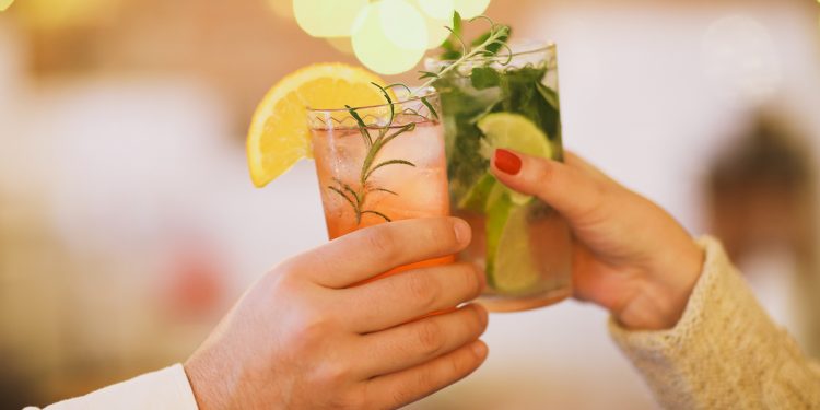 Cocktail cheers. Photographed by Dasha Petrenko. Image via Shutterstock