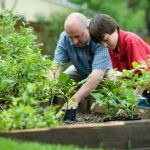 Father and son gardening. Photographed by CDC. Image via Unsplash