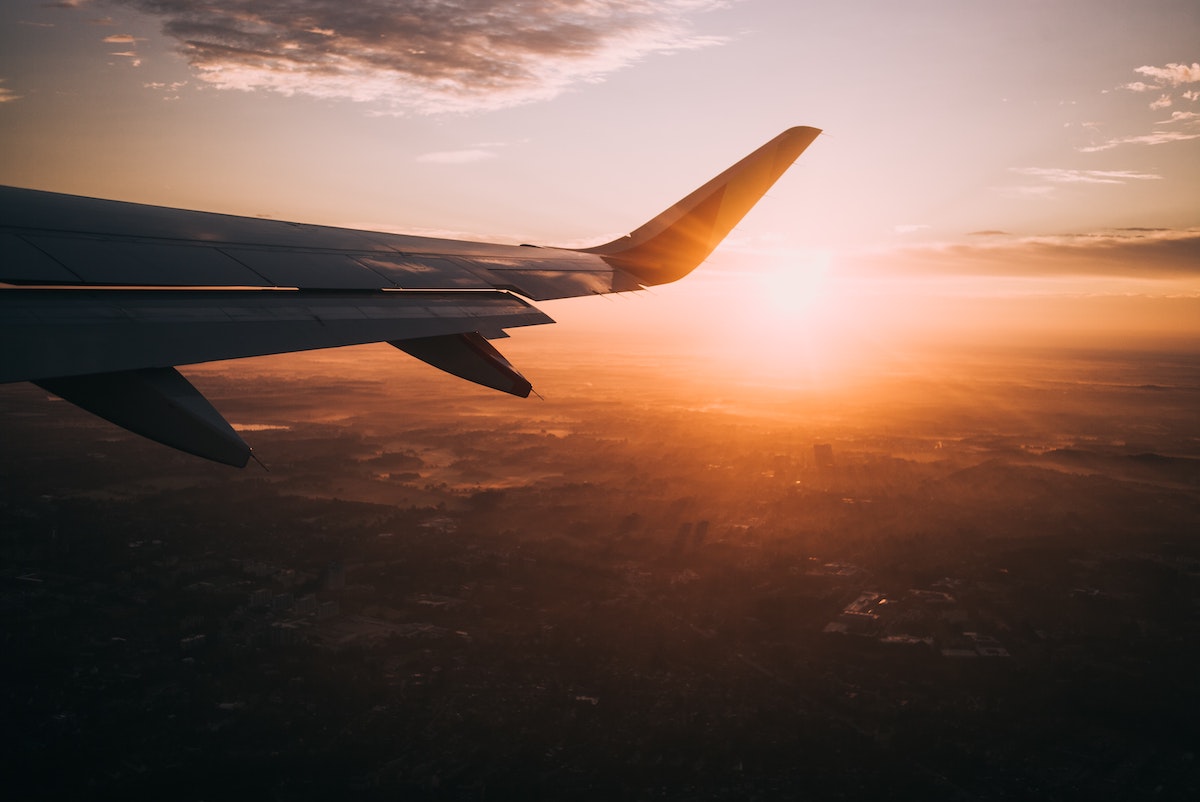 Plane in sunset. Photographed by Nils Nedel. Image via Unsplash.