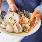 Warm Shellfish with Parsley, Chilli, Olive Oil, Garlic and Lemon Juice dish available at Bannisters by the Sea, Mollymook Beach. Image: Destination NSW