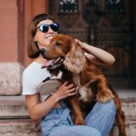 Girl holding dog. Photographed by NazarBazar. Image via Shutterstock