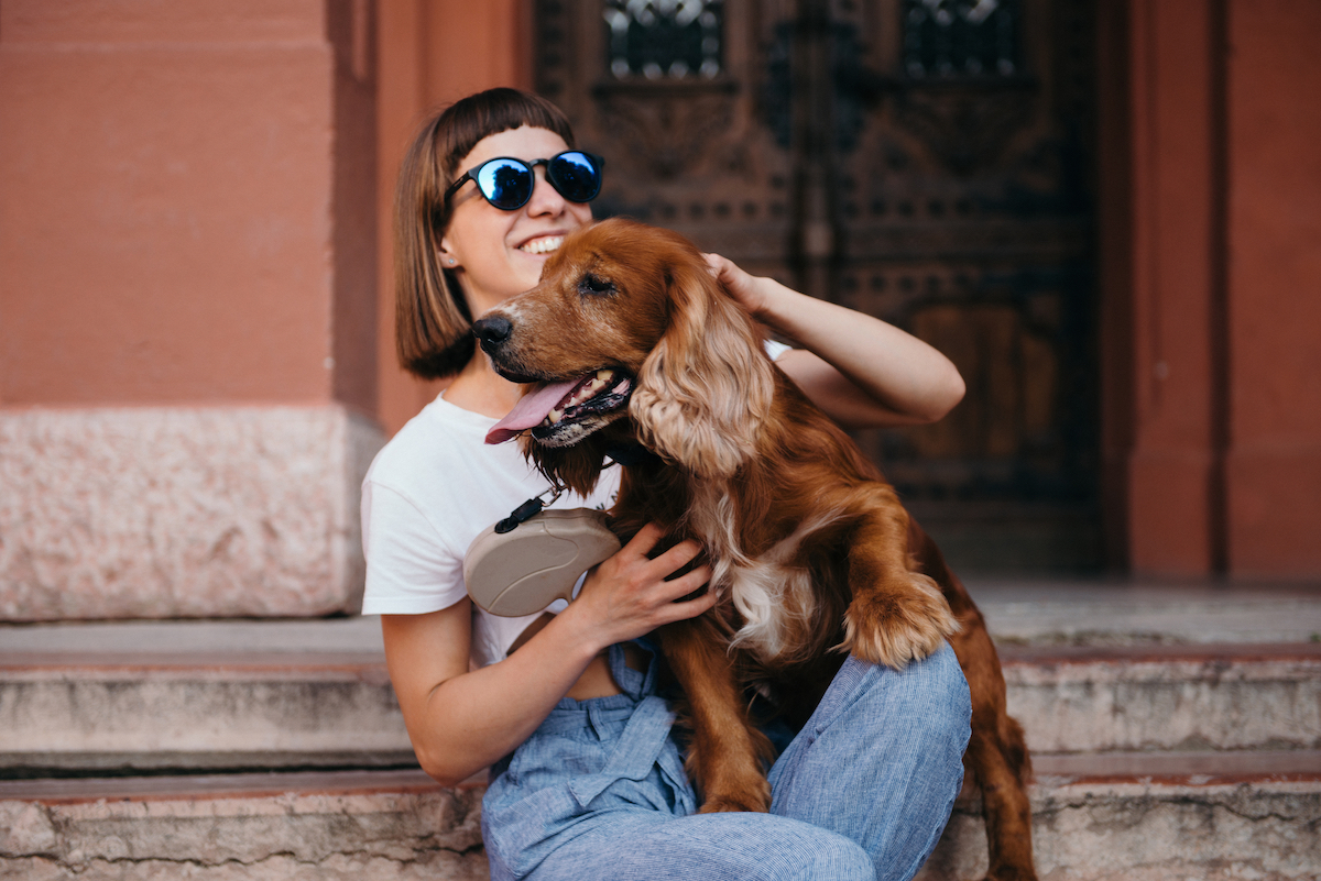 Girl holding dog. Photographed by NazarBazar. Image via Shutterstock