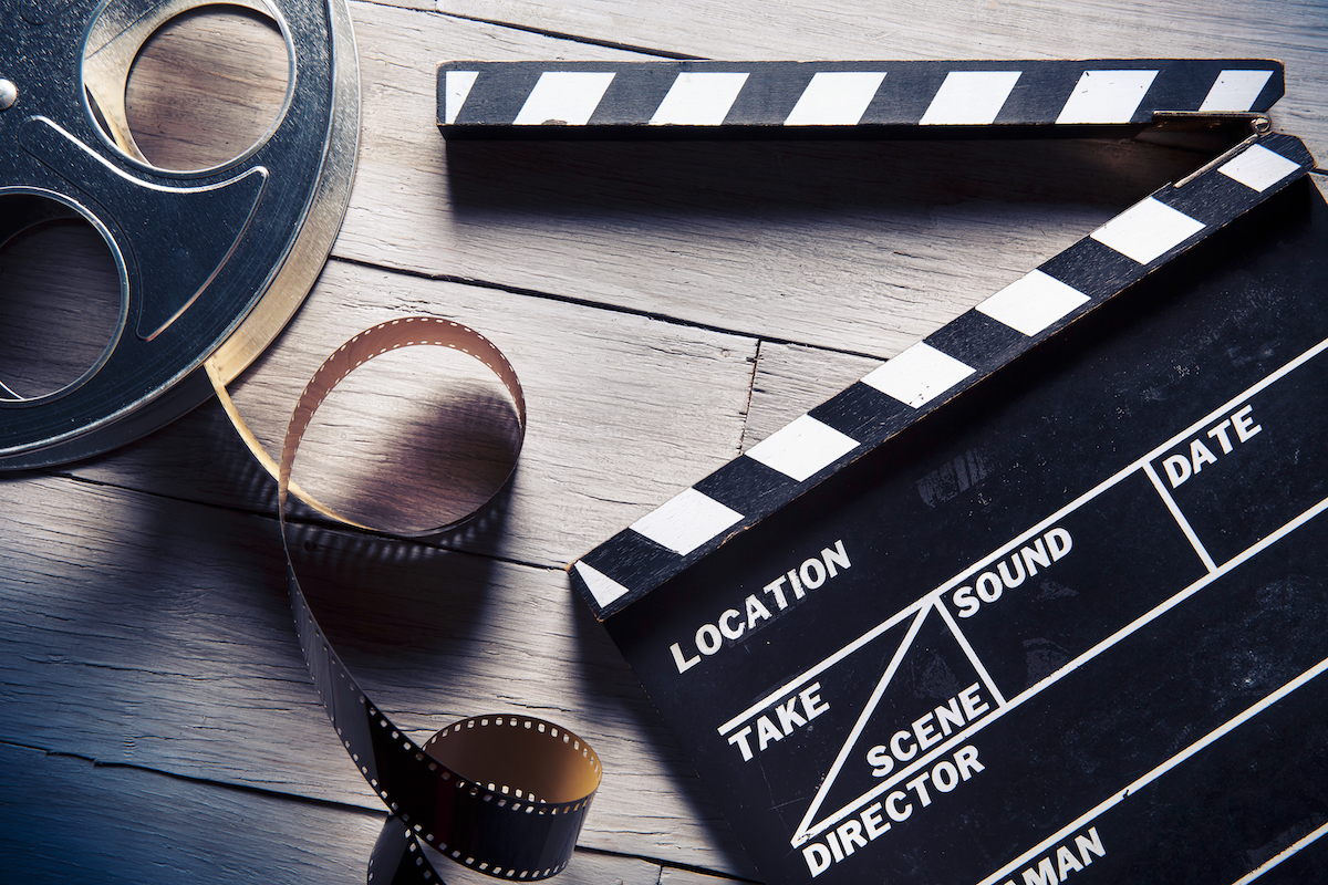 Movie clapper and film reel. Photographed by Fer Gregory. Image via Shutterstock