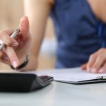 Woman checking finances. Photographed by ldutko. Image via Shutterstock