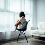 Woman sitting by window. Photographed by Anthony Tran. Sourced via Unsplash