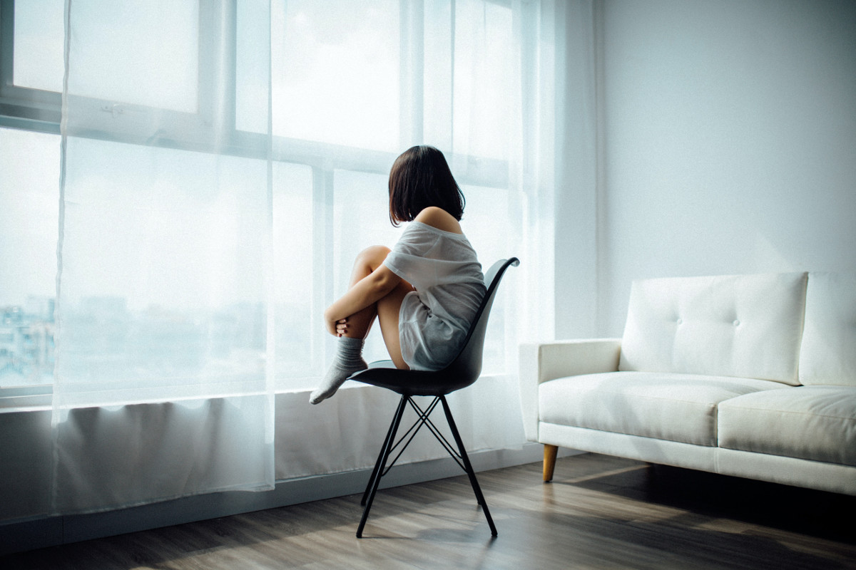 Woman sitting by window. Photographed by Anthony Tran. Sourced via Unsplash
