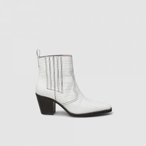 Ganni white leather western boots. Image via The Luxury Closet.