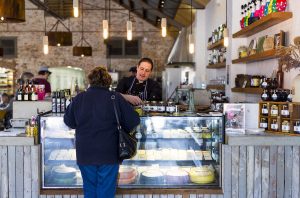 Customer tasting local produce at Coolamon Cheese Factory, Coolamon.